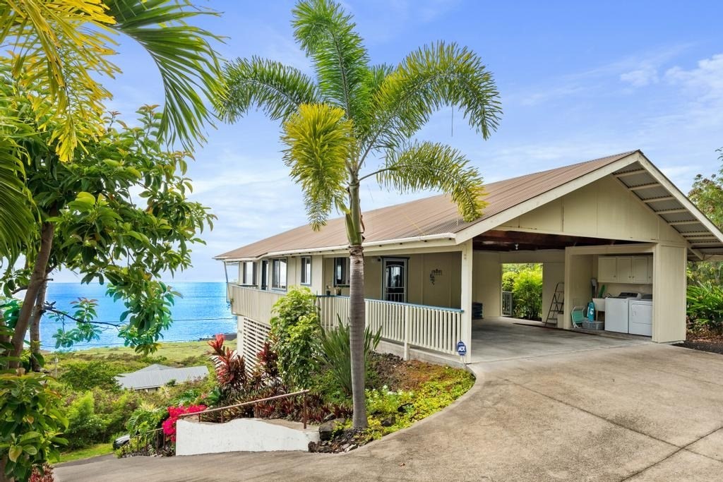 87-3210 Rd G Captain Cook, HI 96704 - Photo 6 of 20 a front view of a house with garden