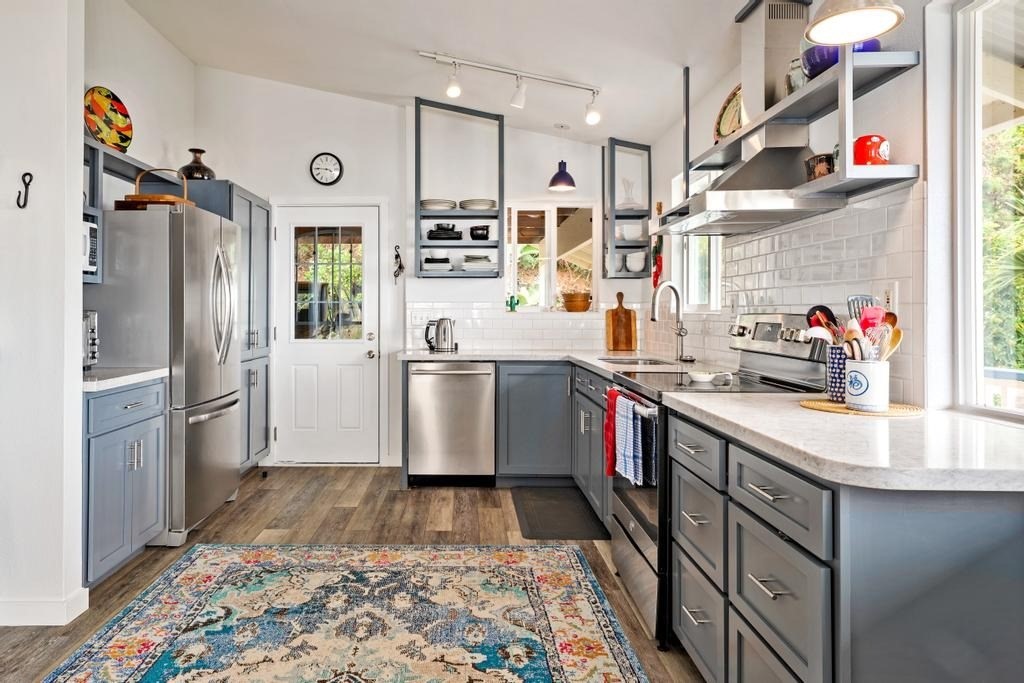87-3210 Rd G Captain Cook, HI 96704 - Photo 7 of 20 a kitchen with stainless steel appliances granite countertop a sink stove and refrigerator