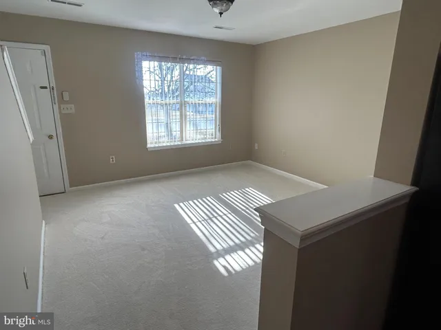 a view of an empty room with windows
