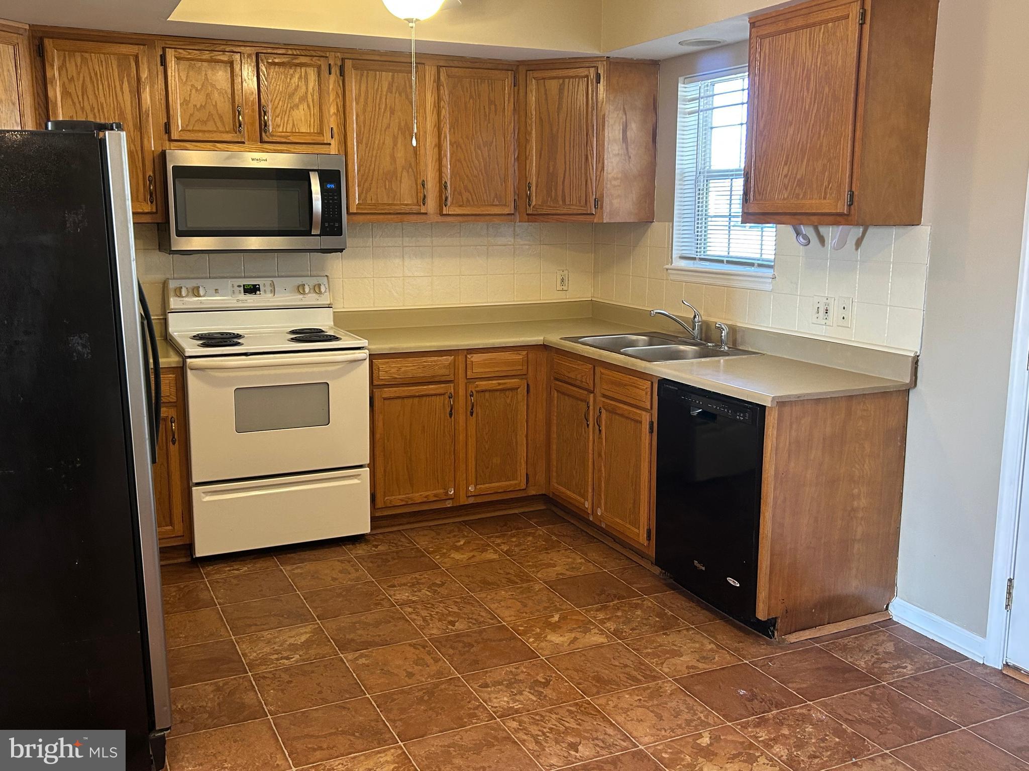 3056 Solar Drive Dover, PA 17315 - Photo 7 of 43 a kitchen with a sink and a stove top oven