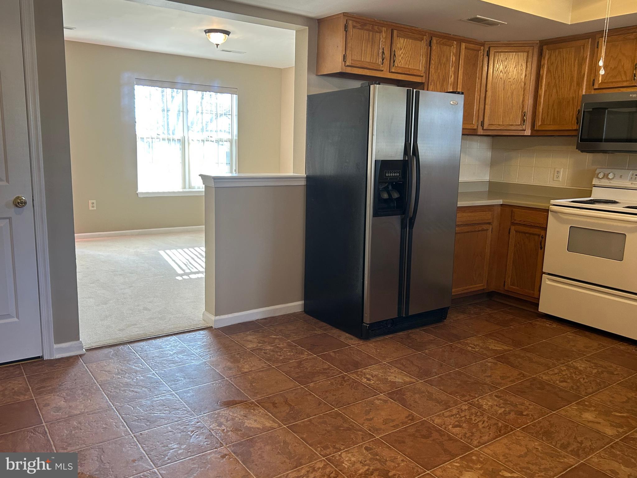 3056 Solar Drive Dover, PA 17315 - Photo 10 of 43 a kitchen with granite countertop a refrigerator and a stove top oven