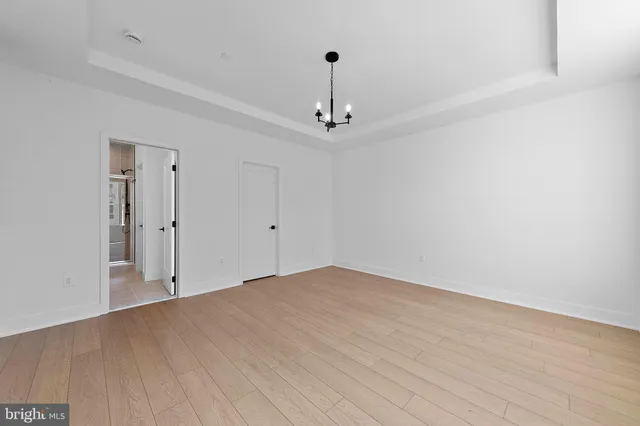 a view of a room with wooden floor