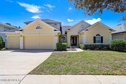 a front view of a house with a yard and garage