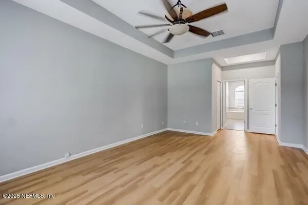 a spacious bathroom with a tub sink and mirror