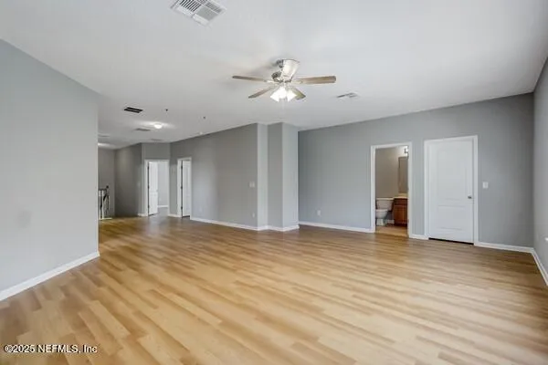 a view of kitchen with refrigerator and microwave