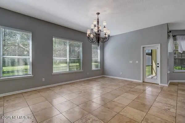 a view of a house with a yard and potted plants