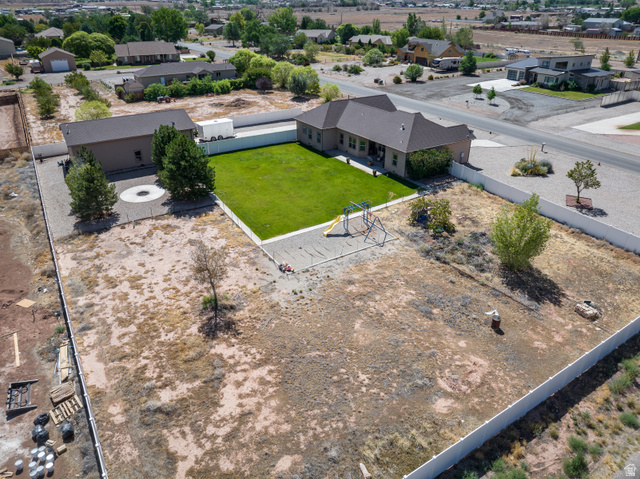 4635 East Sunny Acres Lane Moab, UT 84532 - Photo 5 of 56 Extensive property featuring a single-story residence, detached outbuilding, and a large, fenced backyard with manicured lawn