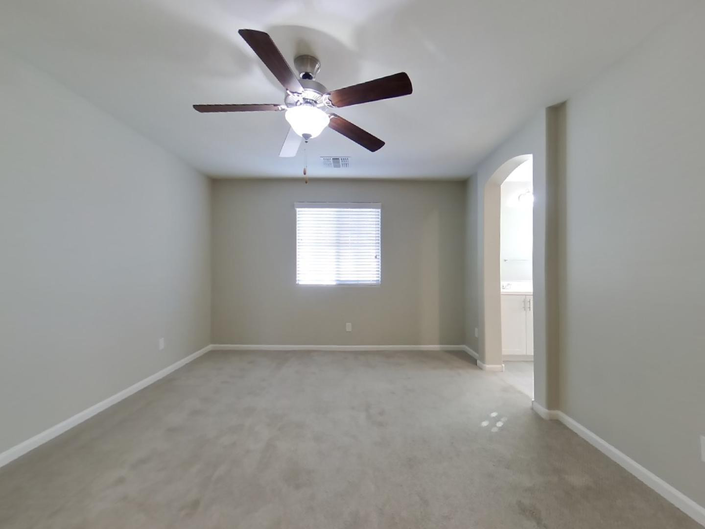 12565 West Via Dona Road Peoria, AZ 85383 - Photo 6 of 17 an empty room with windows and fan