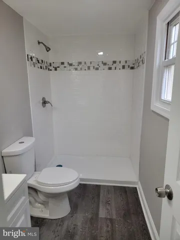 a bathroom with a toilet and a shower