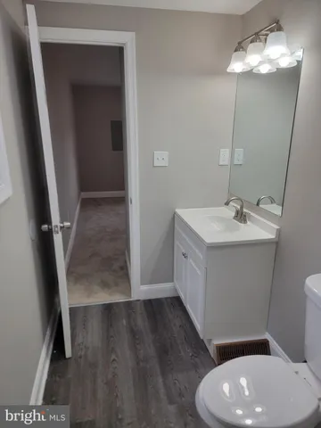 a bathroom with a sink a toilet and a mirror