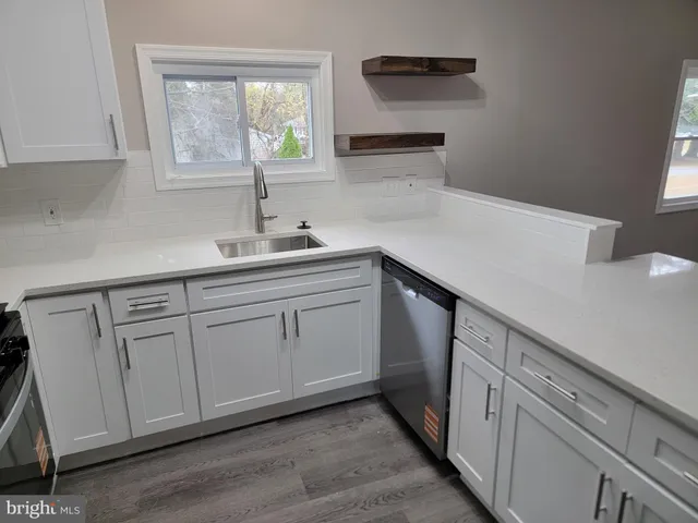 a kitchen with a sink and cabinets