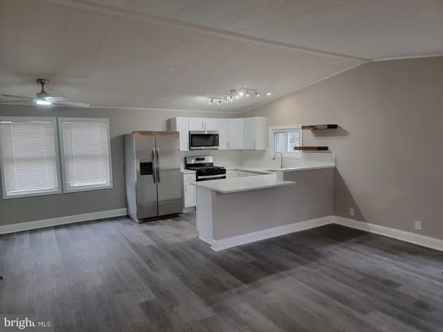 a kitchen with a refrigerator and window
