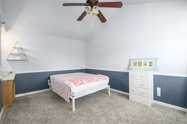 a bedroom with a bed and cabinet
