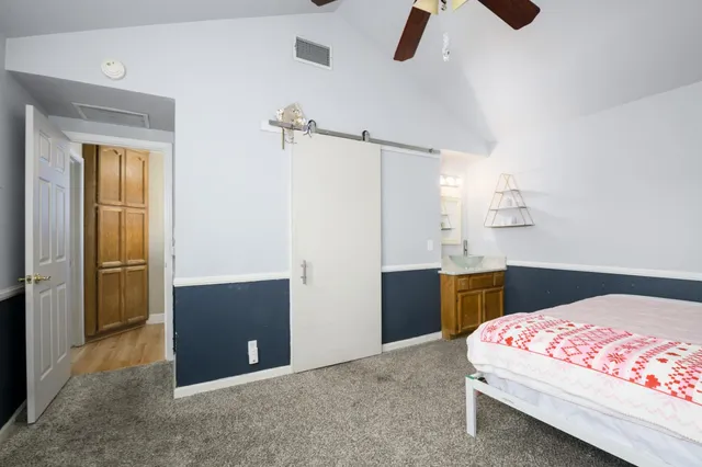 a bedroom with a bed and a chandelier