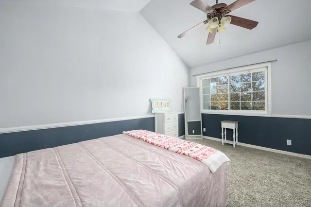 a bedroom with a large bed and a window