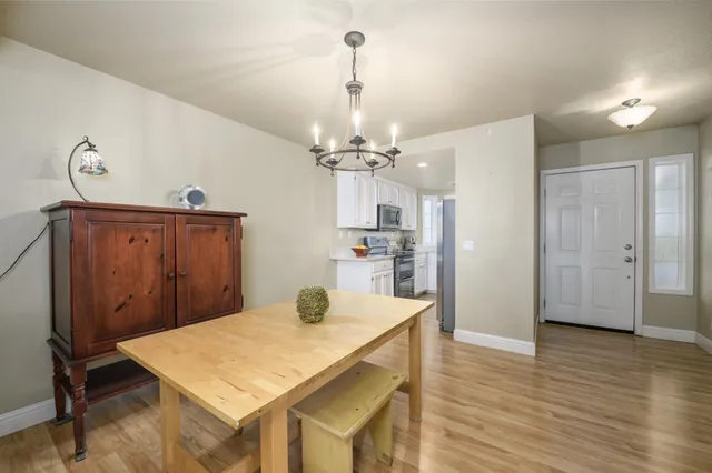 a view of a dining room with furniture and wooden floor