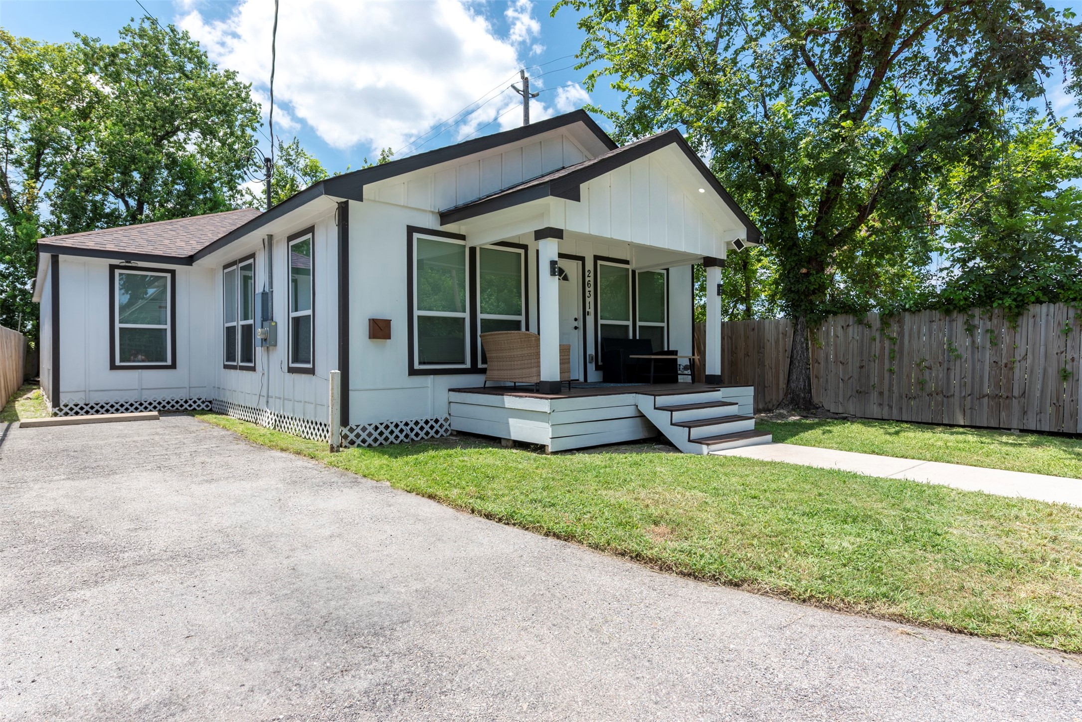 Freshly painted and full of charm, this modern bungalow features a classic black-and-white exterior and a cozy covered front porch—perfect for morning coffee or winding down in the evening. Clean lines and updated finishes give it a crisp, stylish look from the moment you walk up.