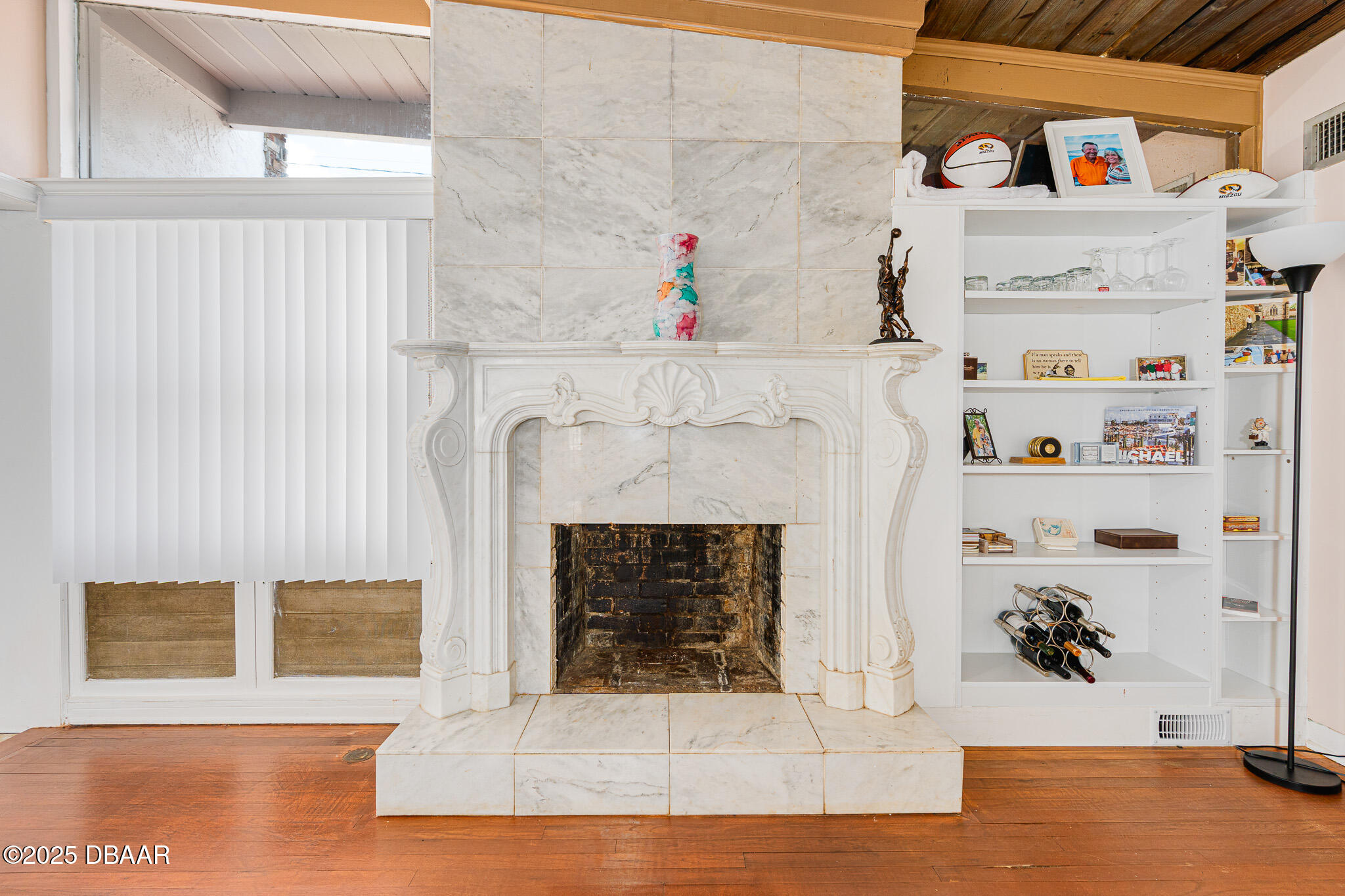 46 Oceanview Avenue Ponce Inlet, FL 32127 - Photo 7 of 79 a white building with a fireplace and wooden floor