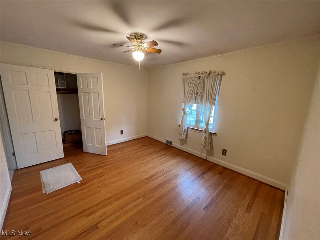2702 Martin Road Zanesville, OH 43701 - Photo 24 of 34 Unfurnished bedroom with a closet, ceiling fan, and hardwood / wood-style flooring
