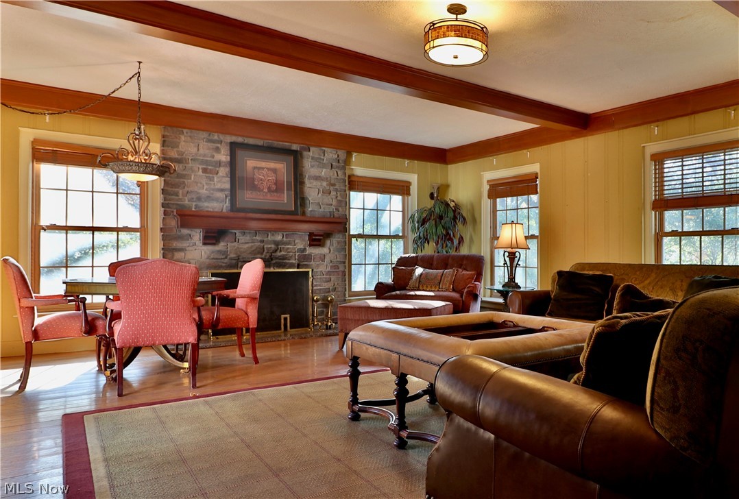 2220 Ridgewood Road Akron, OH 44313 - Photo 14 of 33 Family Room with stone fireplace, wood-beamed ceiling and abundant windows.