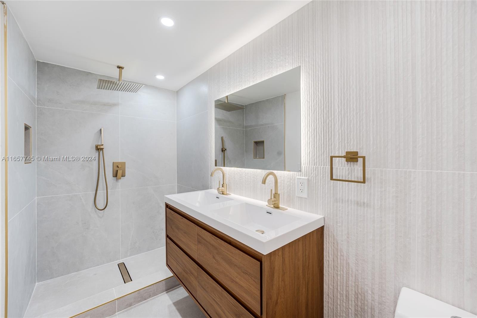 4802 Northwest 11th Avenue Miami, FL 33127 - Photo 12 of 26 a bathroom with a sink a mirror and a shower