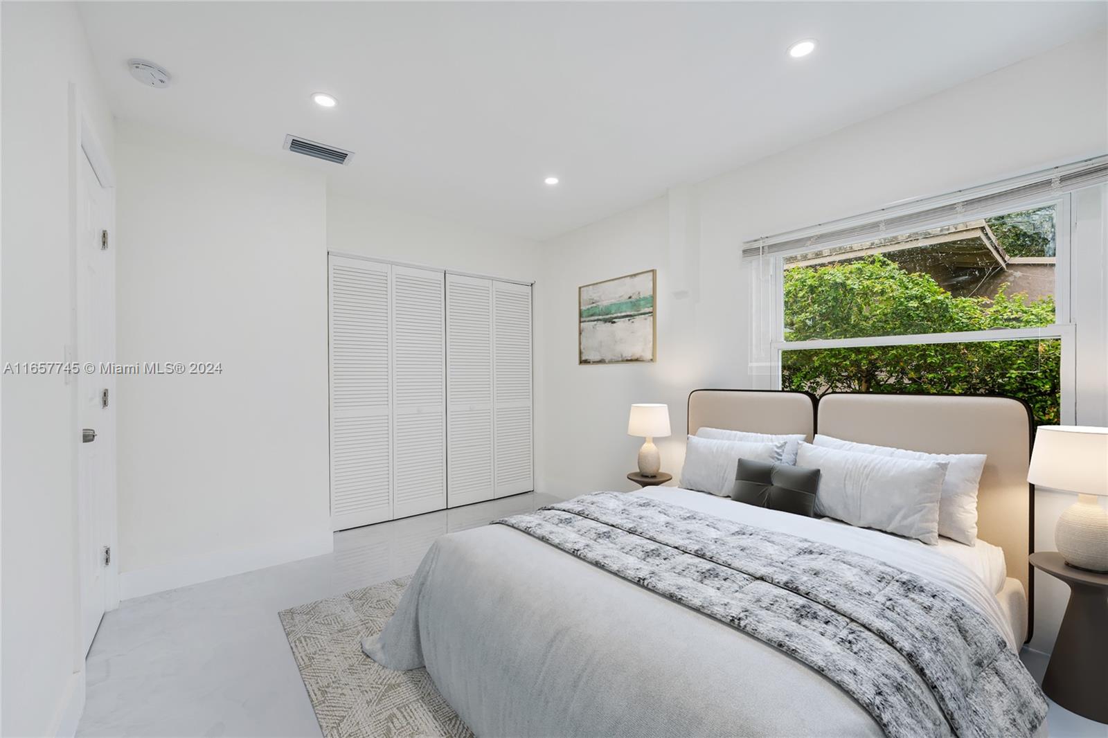 4802 Northwest 11th Avenue Miami, FL 33127 - Photo 18 of 26 a bedroom with a bed and a large window