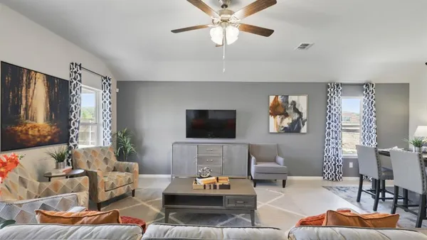 a living room with furniture and kitchen view