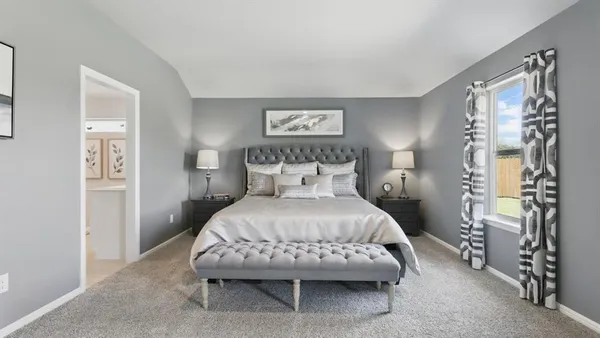 a bedroom with a bed and a dresser