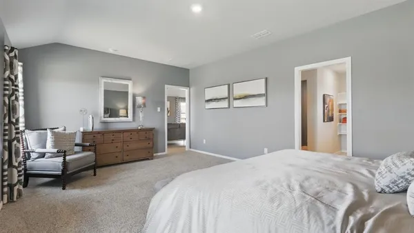 a bedroom with a bed lamp and a window