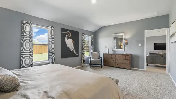 a spacious bedroom with a bed and a table
