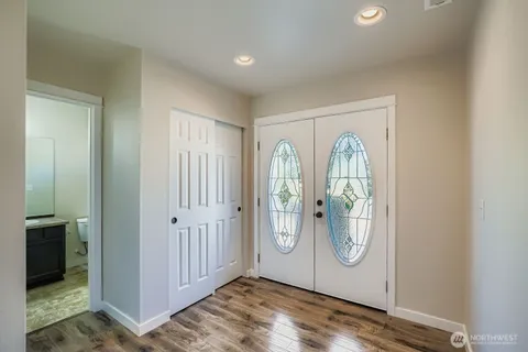 a view of a livingroom with wooden floor and a window