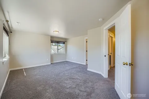 an empty room with windows and closet