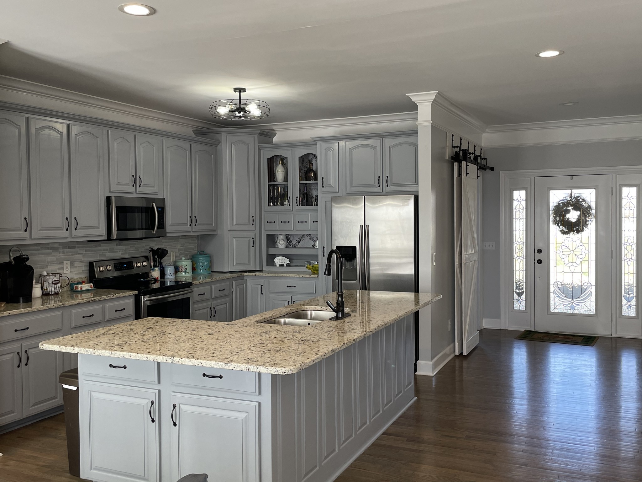 3387 Kinneys Road Cedar Hill, TN 37032 - Photo 13 of 43 a kitchen with kitchen island granite countertop a stove top oven a sink dishwasher a refrigerator and cabinets with wooden floor
