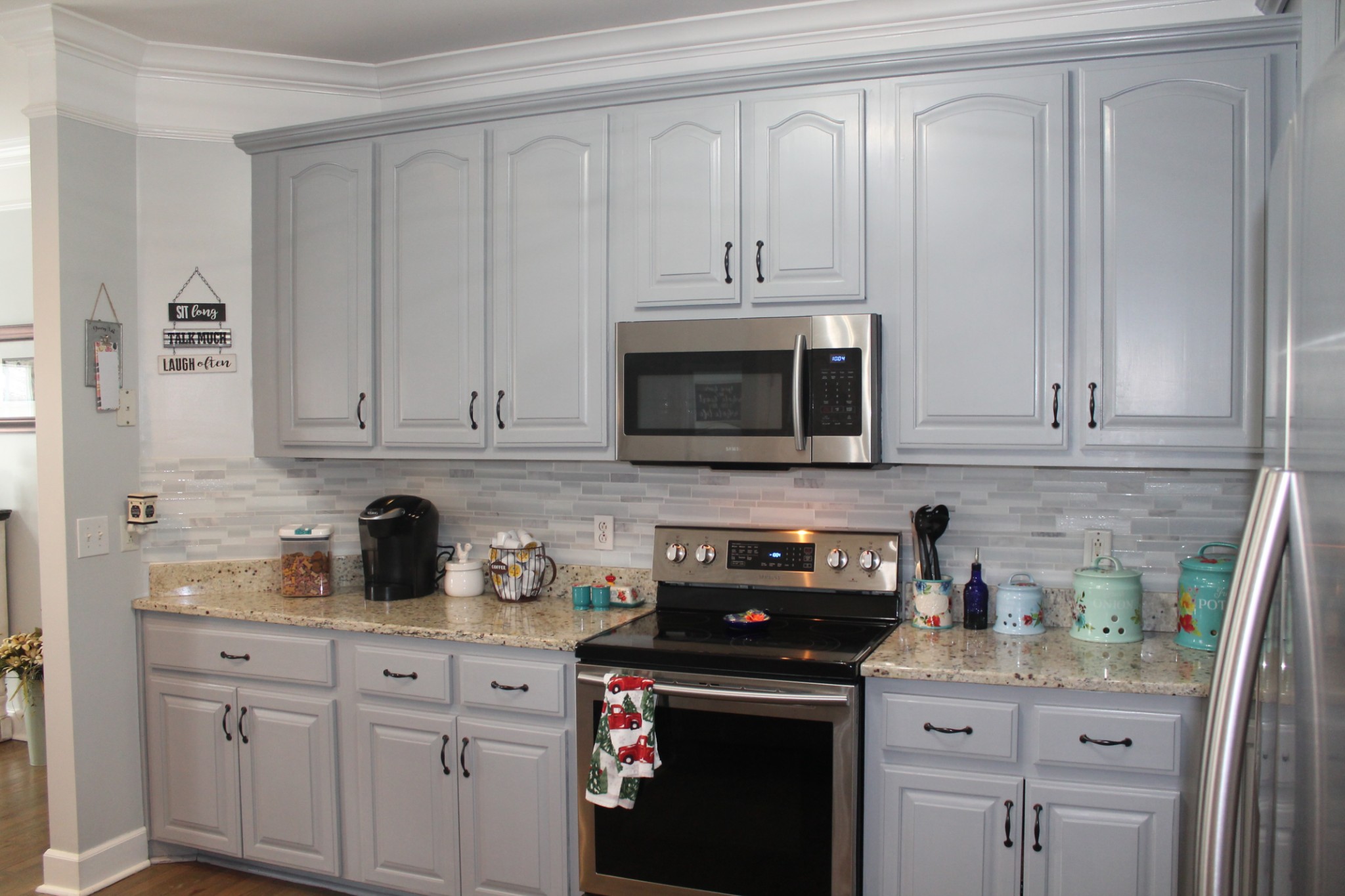 3387 Kinneys Road Cedar Hill, TN 37032 - Photo 19 of 43 a kitchen with stainless steel appliances granite countertop white cabinets a sink and dishwasher