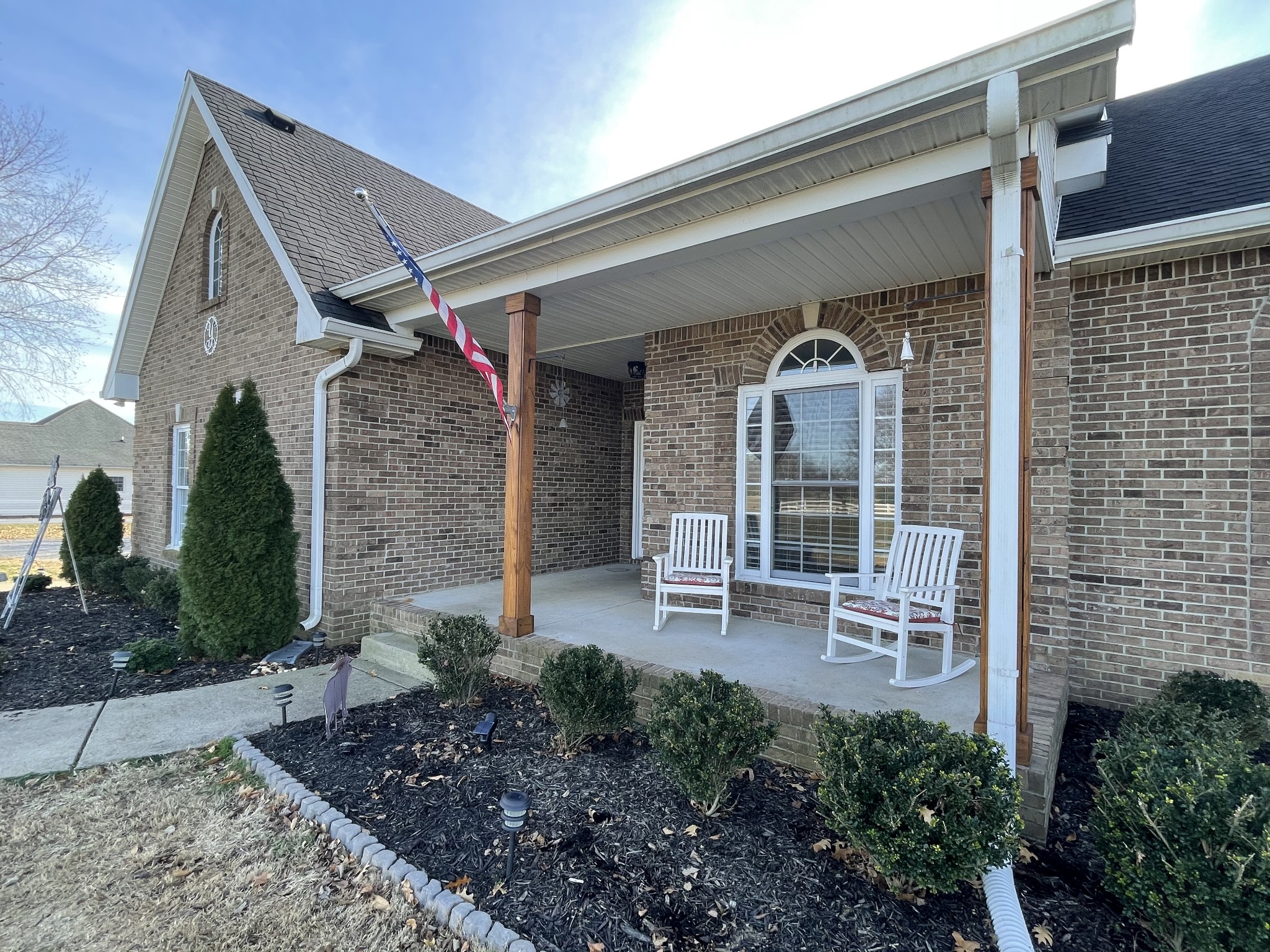 3387 Kinneys Road Cedar Hill, TN 37032 - Photo 7 of 43 a front view of a house with outdoor seating and plants