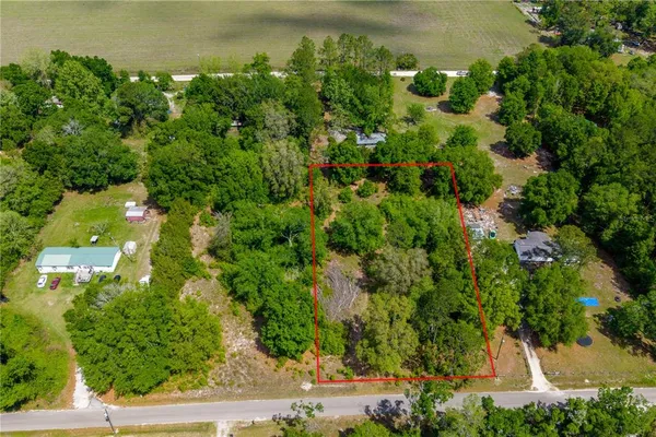 an aerial view of a houses with a yard