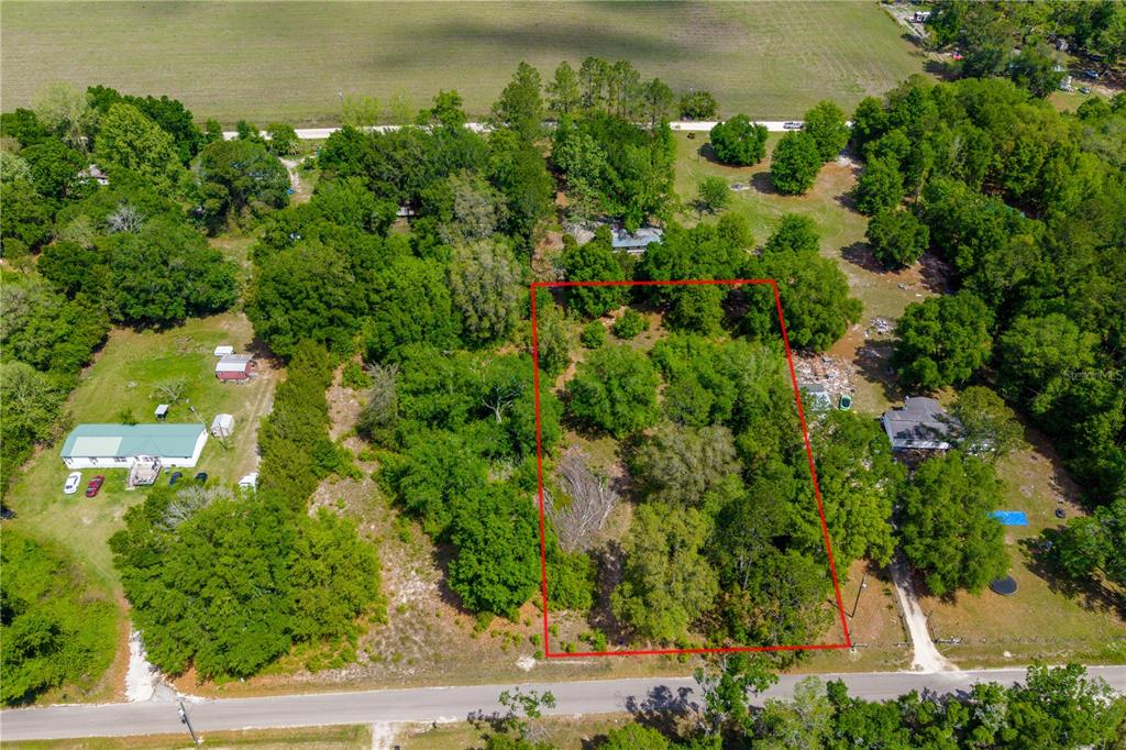 an aerial view of a houses with a yard