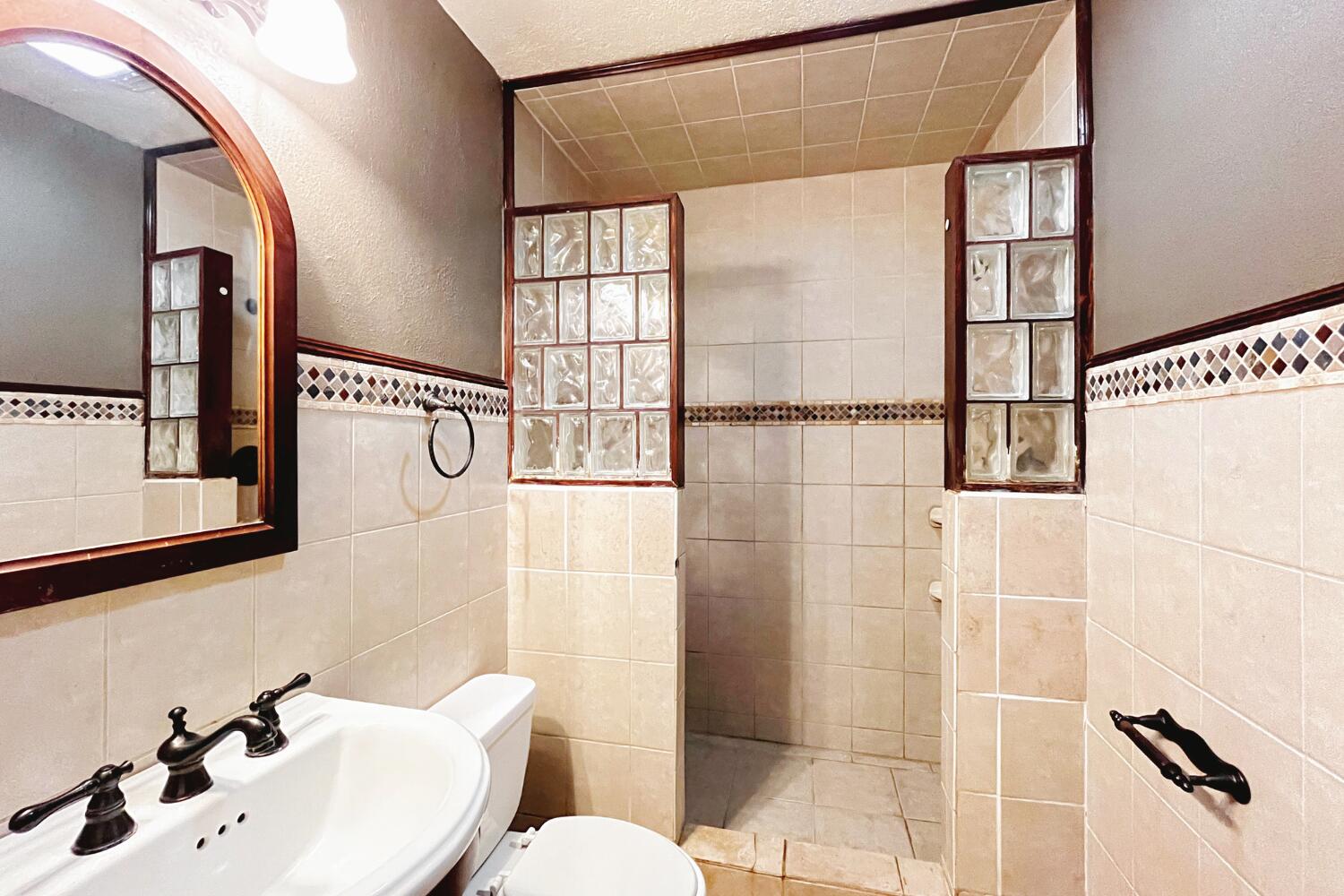 3002 21st Street Lubbock, TX 79410 - Photo 11 of 41 a bathroom with a sink and mirror
