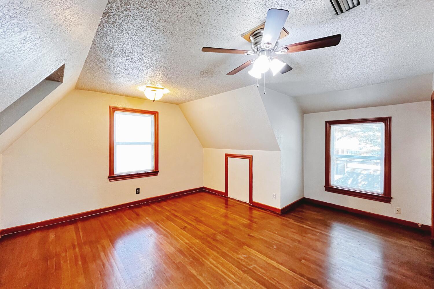 3002 21st Street Lubbock, TX 79410 - Photo 17 of 41 wooden floor in an empty room with a window