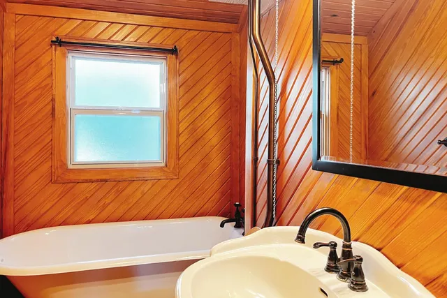 a bathroom with a sink a mirror and a bathtub