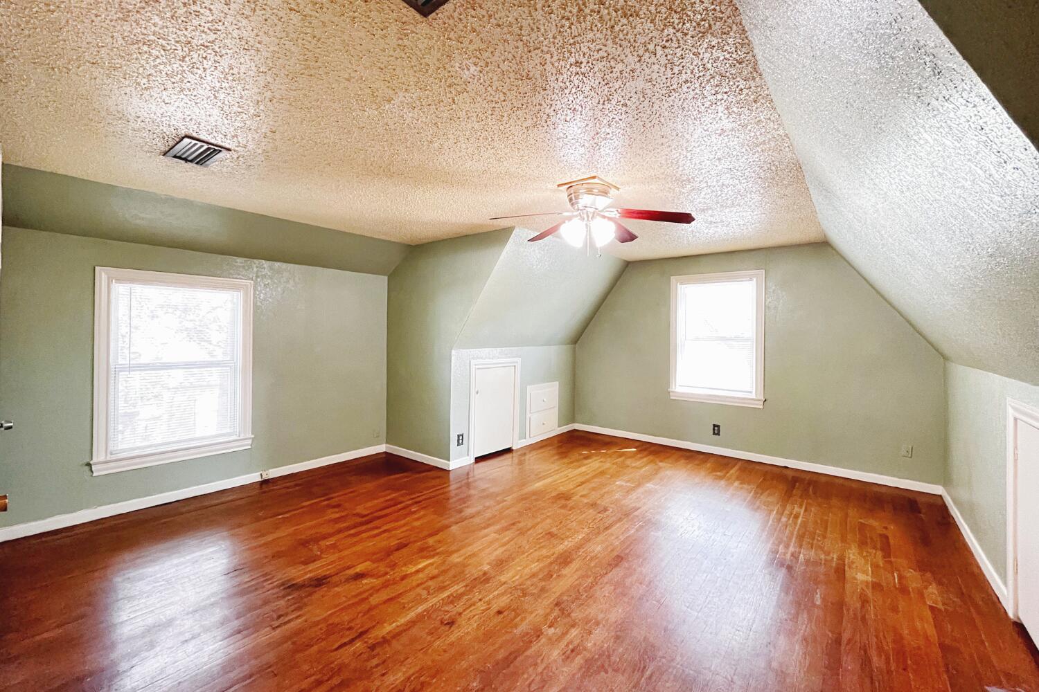 3002 21st Street Lubbock, TX 79410 - Photo 20 of 41 an empty room with wooden floor and windows