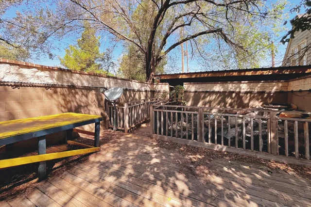 a view of a yard with wooden fence