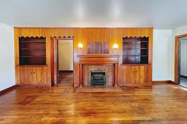 a view of a livingroom with fireplace and window
