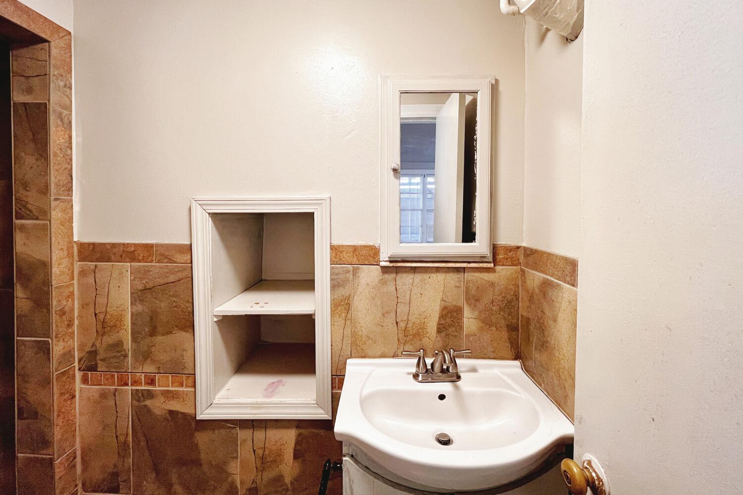 3002 21st Street Lubbock, TX 79410 - Photo 35 of 41 a bathroom with a sink and a mirror