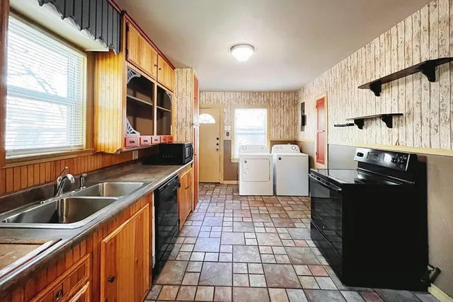 a kitchen with a sink a stove and refrigerator