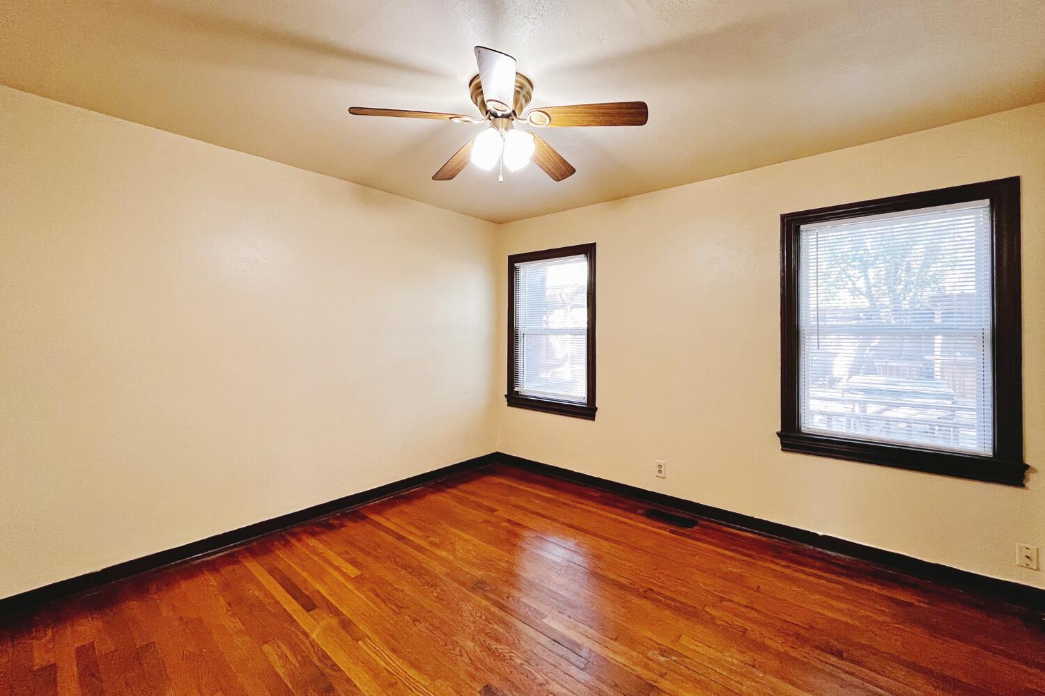3002 21st Street Lubbock, TX 79410 - Photo 9 of 41 a view of an empty room with wooden floor and a window