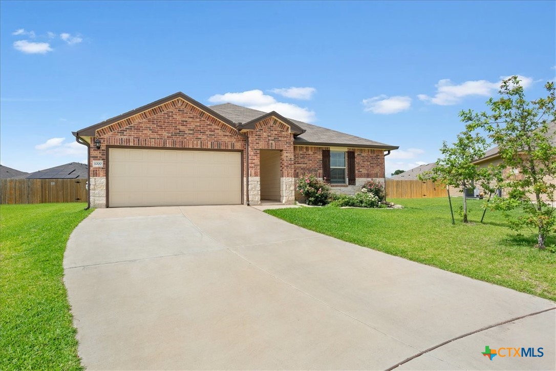 1000 Velvet Court Troy, TX 76579 - Photo 2 of 25 a front view of a house with a yard and garage