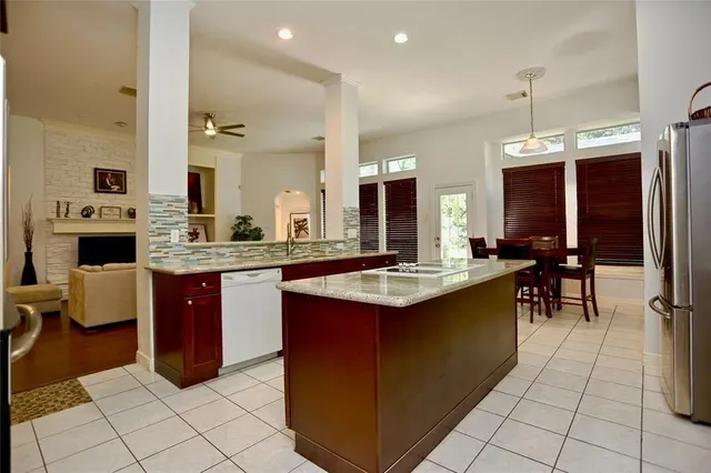a kitchen with stainless steel appliances kitchen island granite countertop a sink and cabinets