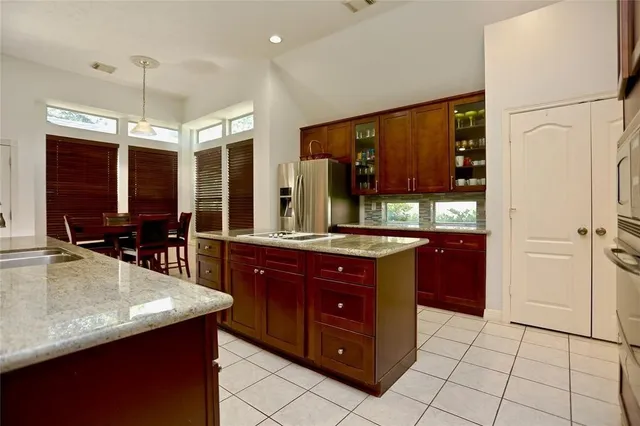 a kitchen with a sink counter top space and stainless steel appliances