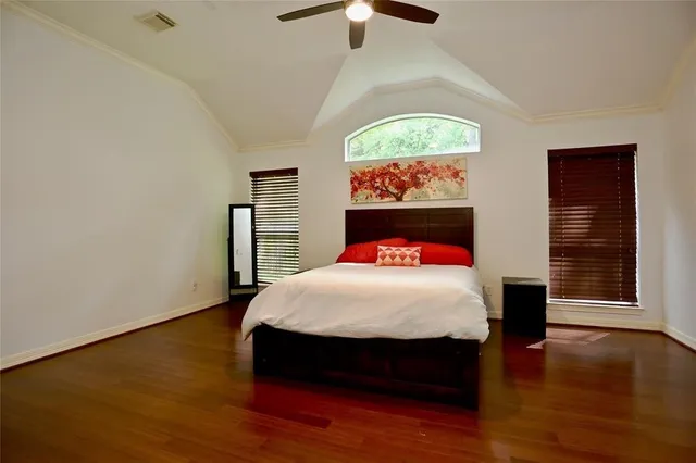 a bed sitting in a bedroom next to a window